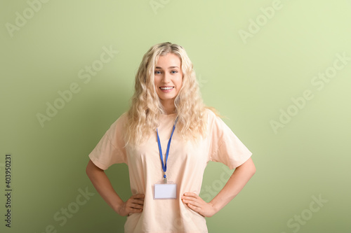 Young woman with blank badg...