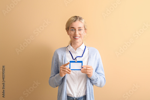 Young woman with blank badg...