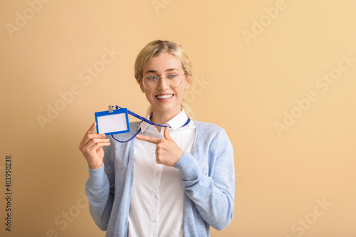 Young woman with blank badg...