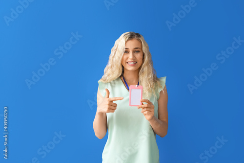 Young woman with blank badg...