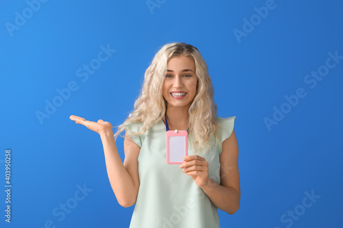 Young woman with blank badg...