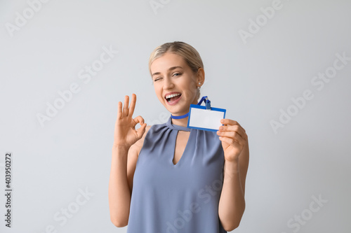 Young woman with blank badg...
