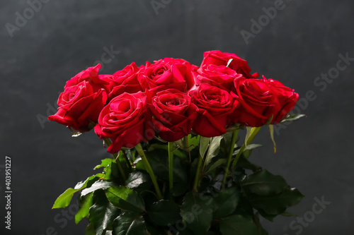 Bouquet of beautiful red roses on dark background
