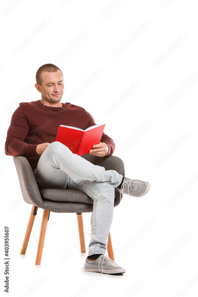 Man with book sitting in armchair on white background Man with book sitting in armchair on white background