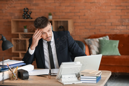 Stressed businessman trying...