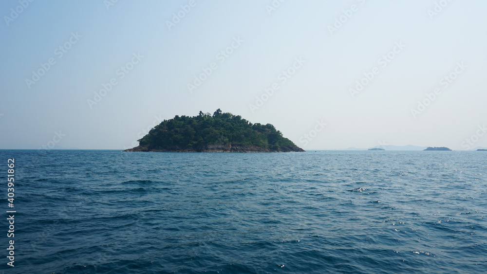 Travel by sea in Thailand by ship. View of the open ocean, green Islands and gray sky in smog. Green water with waves. Sailing between the Islands. Ship from different sides: stern, bow, rope, anchor. Travel by sea in Thailand by ship. View of the open ocean, green Islands and gray sky in smog. Green water with waves. Sailing between the Islands. Ship from different sides: stern, bow, rope, anchor.
