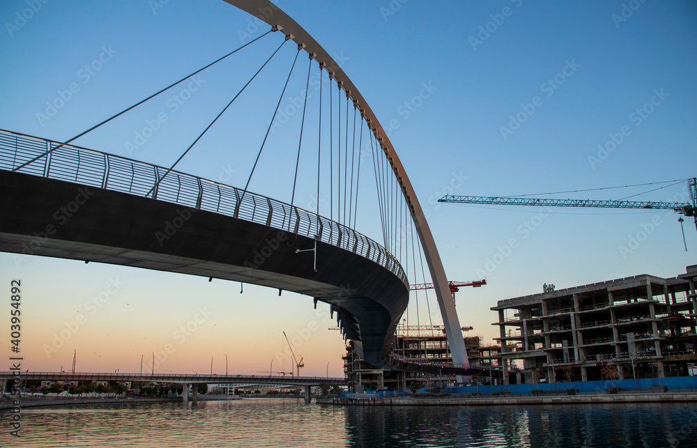 Obraz premium Dubai, UAE - 01.08.2021 Bridge over a Dubai Water canal known as Tolerance bridge. Outdoors