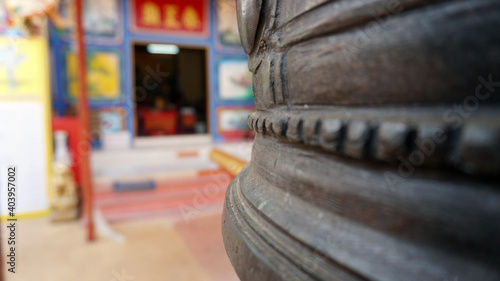 Chinese temple on Koh Chang island of Thailand. Bright colors of the temple, dragon and elephant sculptures. Flowers all around. The smoke from the sticks is coming. Hieroglyphs on the walls of bell. photo