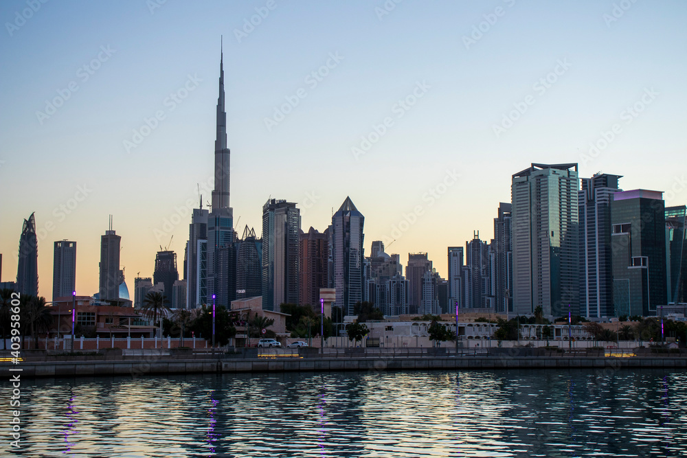 Obraz premium Dubai, UAE - 01.08.2021 View of the Dubai city skyline at Dubai Water Canal. Business Bay district. Tallest building in the world Burj Khalifa can be seen in the picture. Outdoors
