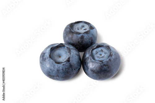 Three fresh blueberries formed a triangle pattern isolated on white background. Closeup and macro.