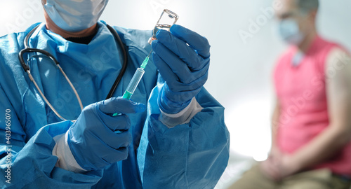 A medical staff prepares a coronavirus vaccine in syringe for vaccination. Covid-19 Vaccination