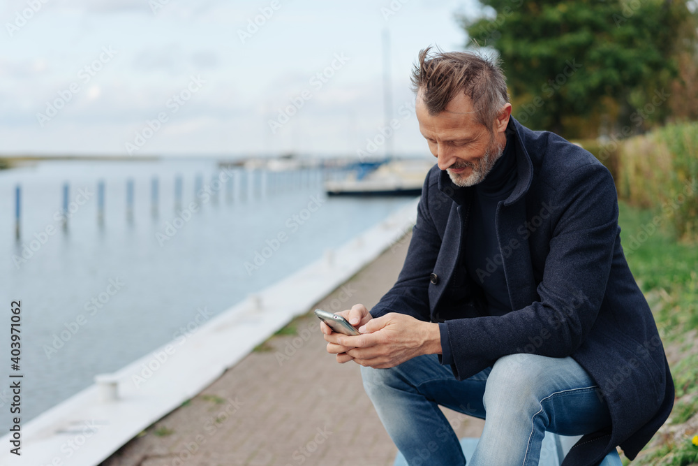 Man relaxing on a bench at the waterfront Man relaxing on a bench at the waterfront