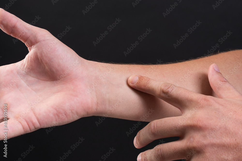 Man's hand with gesture of using smart tech wearable gadgets