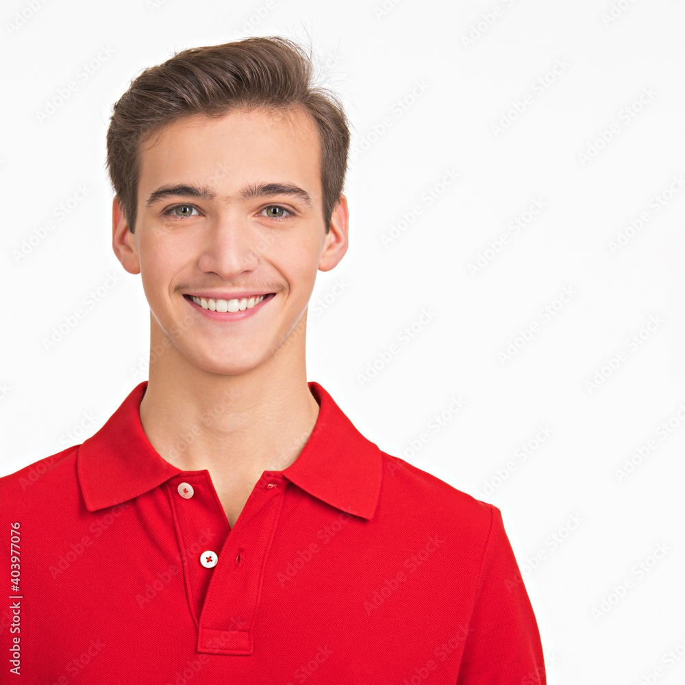 Photo of young happy man looking at camera. Portrait of smiling handsome guy posing at studio. Attractive male face with a smile. Photo of young happy man looking at camera. Portrait of smiling handsome guy posing at studio. Attractive male face with a smile.