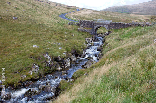 A small stone bridge over a stream, minor road above Talla Reservoir, Southern Uplands, Scottish Borders, Scotland, UK. photo