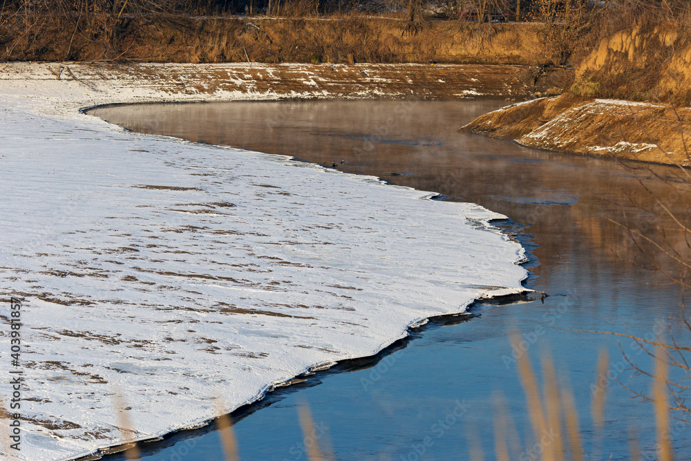 Landscape of a cold autumn river with snow outside the city. Landscape of a cold autumn river with snow outside the city.