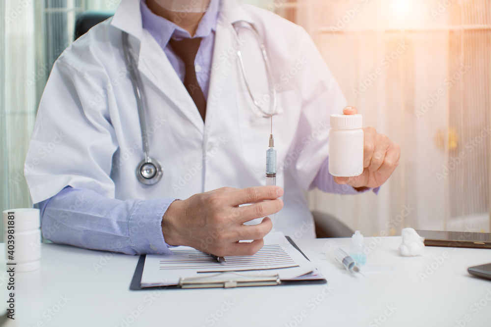 doctor holding a syringe doctor holding a syringe