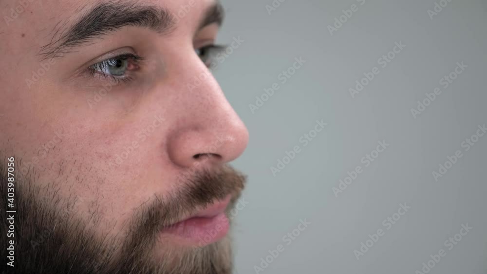 Close up side face view of a soldier in a military uniform looking straight confident and serious in studio on white background. Close up side face view of a soldier in a military uniform looking straight confident and serious in studio on white background.