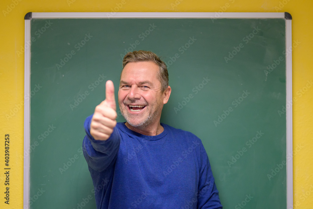 Male teacher giving a thumbs up
