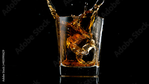 Ice Cube falling into Glass of Whisky, Freeze Motion.