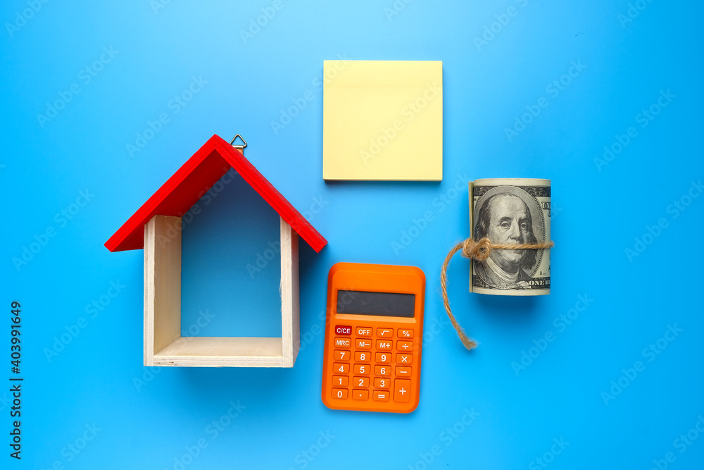 A picture of house miniature with copyspace notepad, calculator and pen for real estate ownership concept. A picture of house miniature with copyspace notepad, calculator and pen for real estate ownership concept.