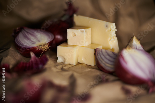 cheese and purple onion isolated on craft paper. Low depth of field photo