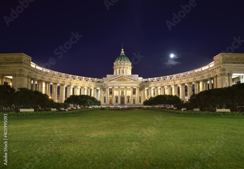 Kazan Cathedral in the night lights. Colonnade with a Central portico and a high dome against the blue sky with the moon. Architecture of the XIX century