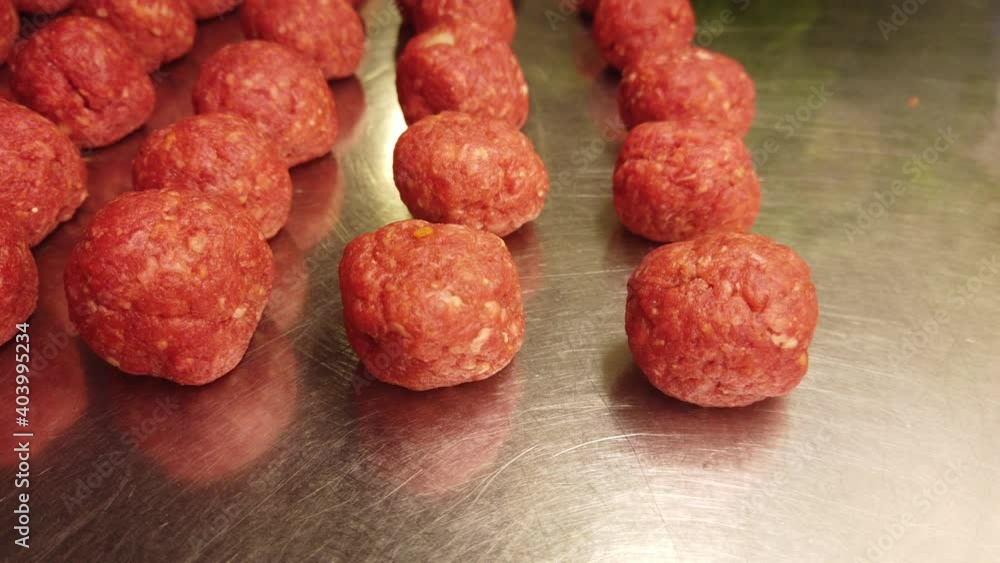 Short video in 4k showing hand-made meatballs ready to be cooked in tomato sauce Short video in 4k showing hand-made meatballs ready to be cooked in tomato sauce