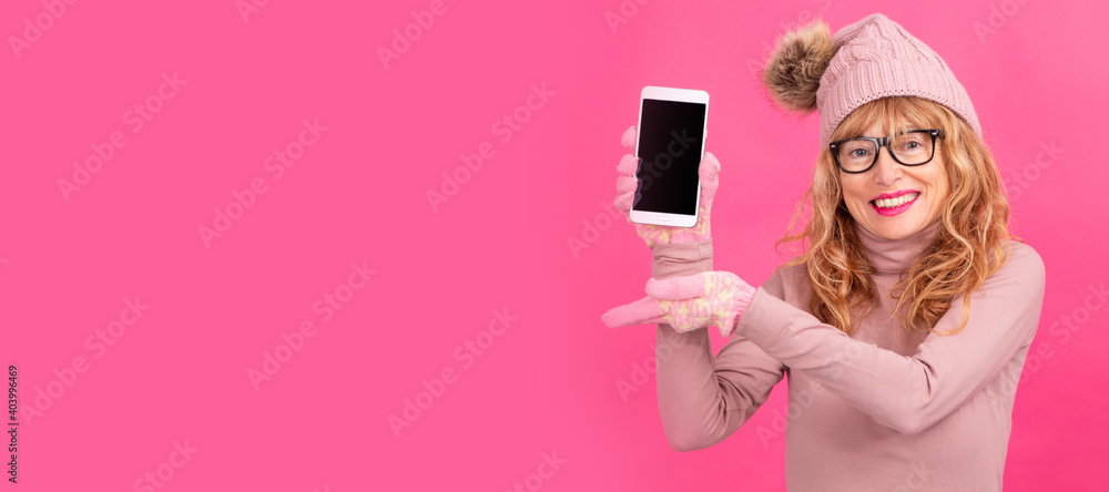 adult or senior woman with mobile phone on color background with space for text or ads adult or senior woman with mobile phone on color background with space for text or ads