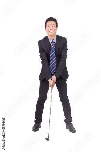 Business man holding golf swing and smiling at the camera © eastfenceimage