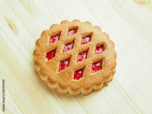 ookies with marmalade on wooden surface photo