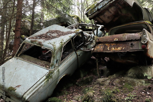 Vintage abendoned cars rusting in the forest photo