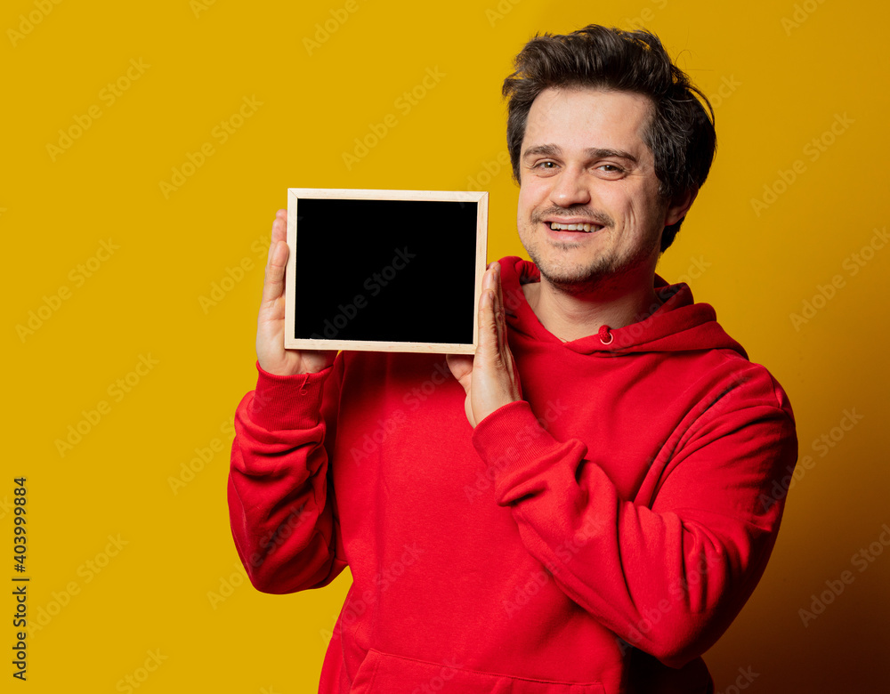 white smiling guy in red sweatshirt on yellow background white smiling guy in red sweatshirt on yellow background