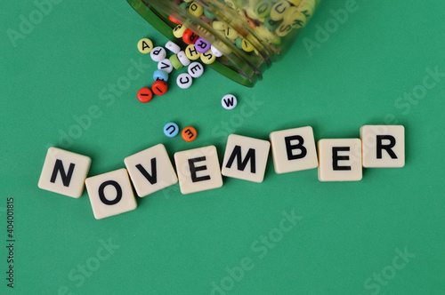 Top view of alphabet beads and alphabet letters with text NOVEMBER.