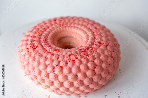 Pink mousse cake in the form of a donut in circles