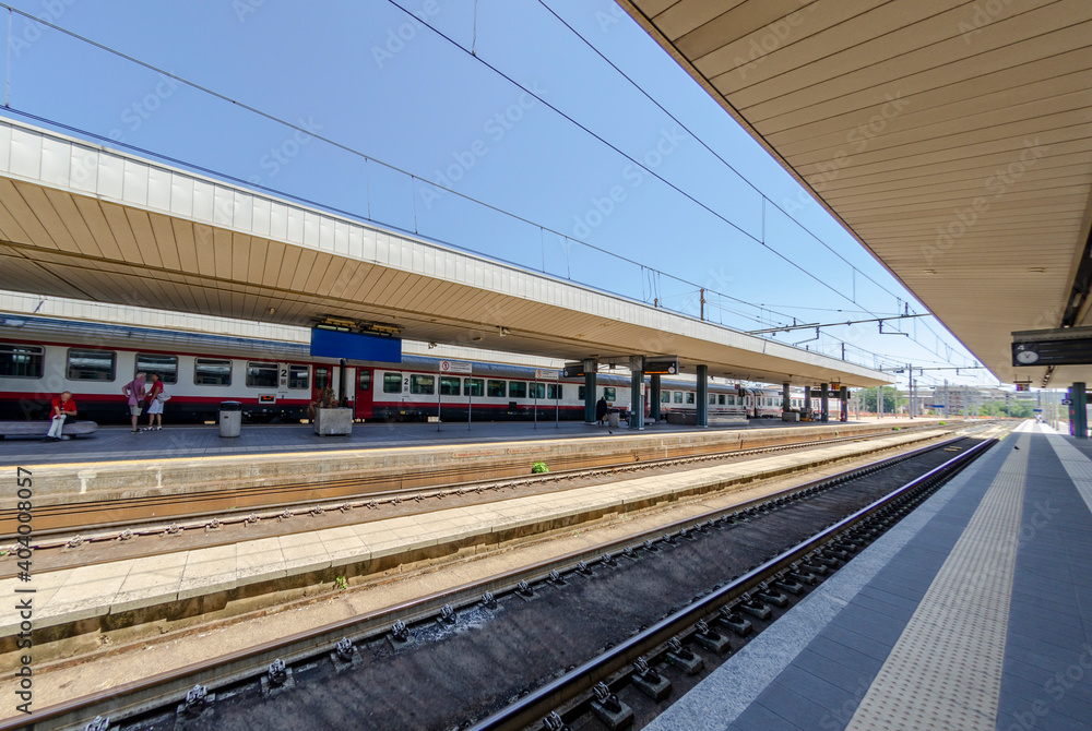 Railway station with train waiting on the tracks Railway station with train waiting on the tracks