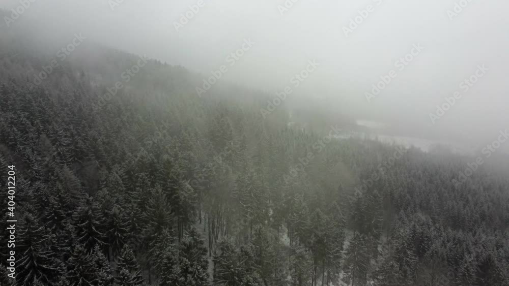 View of the snowy forest. Shot shot with a drone. Aerial view of a snowstorm in the mountains. View of the snowy forest. Shot shot with a drone. Aerial view of a snowstorm in the mountains.