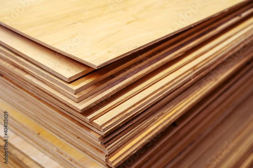 A lot of plywood sheets are stacked. Trade in wood building materials. Close-up