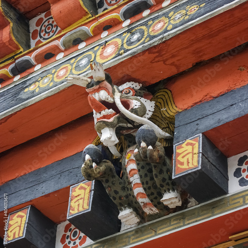 Colorful traditional painted dragon wood sculpture used as corbel in Tashichho dzong in Thimphu, Bhutan photo
