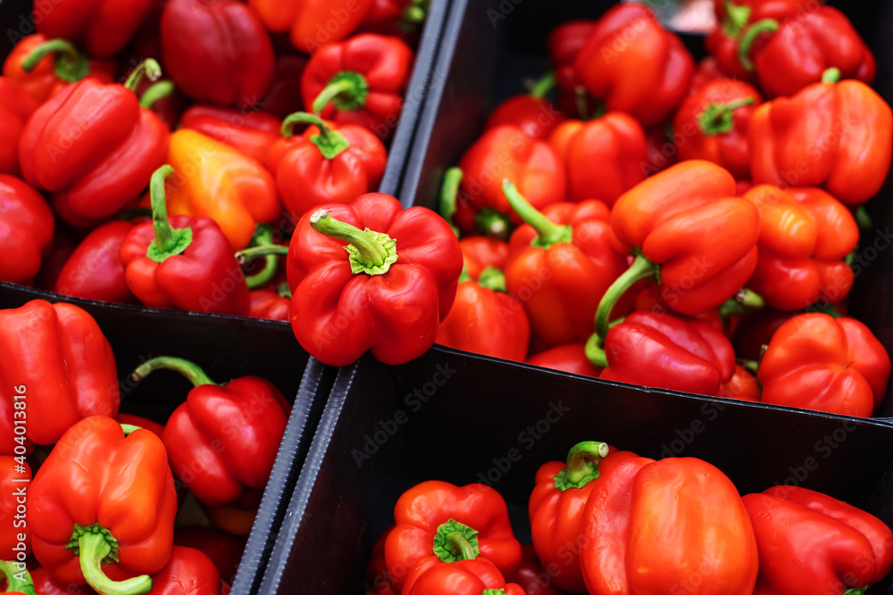 Sweet, red peppers in plastic boxes. Trade and export of fruits to different countries. Close-up Sweet, red peppers in plastic boxes. Trade and export of fruits to different countries. Close-up