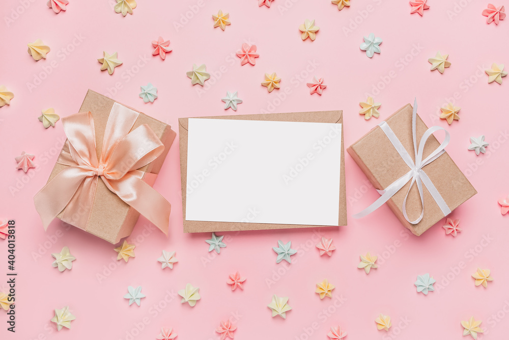 Gifts with note letter on isolated pink background with sweets, love and valentine concept