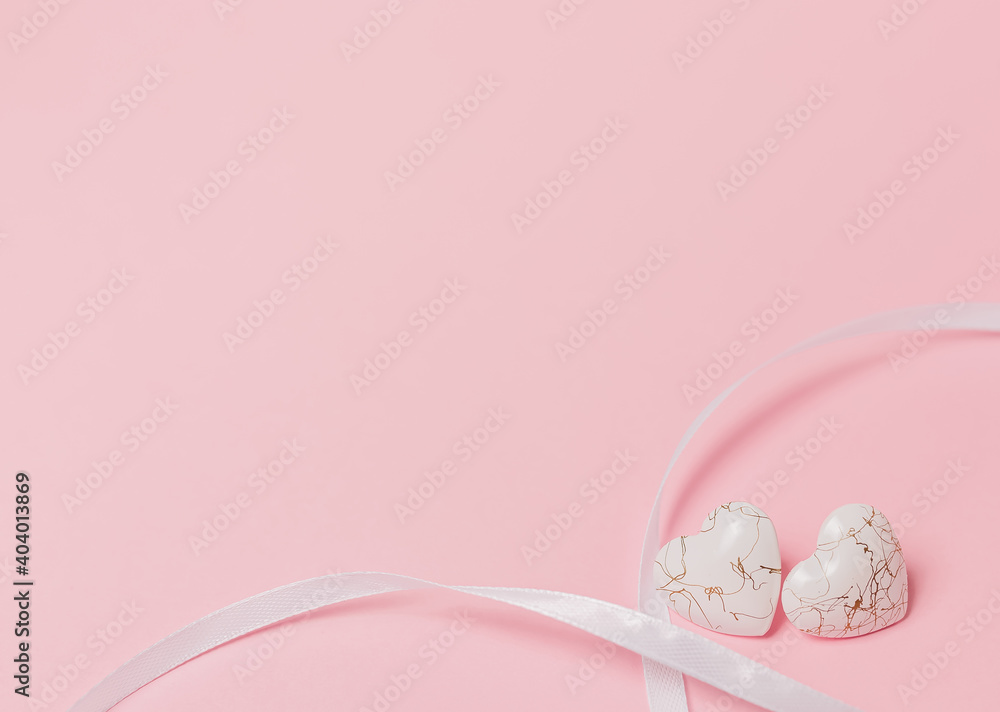 shape heart with wihte ribbon on isolated pink background