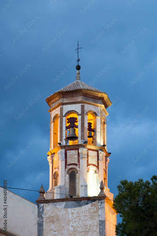 very nice illuminated church tower painted in yellow and balcony with bells very nice illuminated church tower painted in yellow and balcony with bells