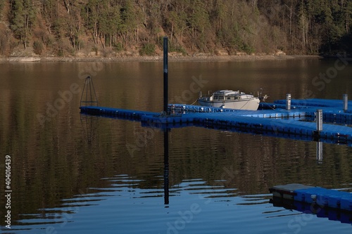 Boat on the lake, empty, free berth for small boats in a bay on the Slapy dam south of Prague. photo