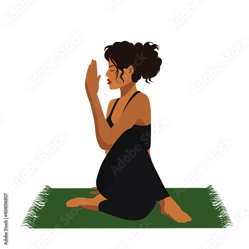 The girl does yoga online in the lotus position on the mat