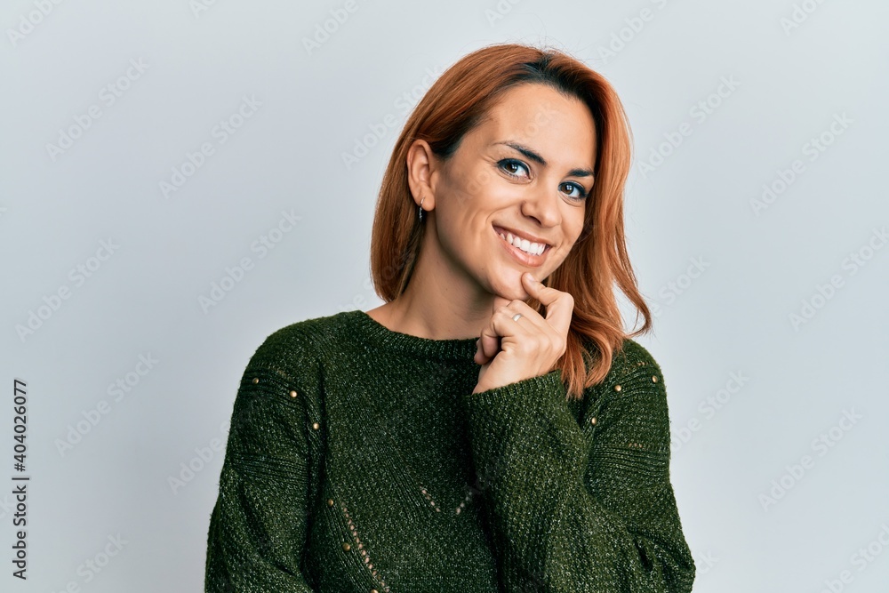 Hispanic young woman wearing casual winter sweater smiling looking confident at the camera with crossed arms and hand on chin. thinking positive. Hispanic young woman wearing casual winter sweater smiling looking confident at the camera with crossed arms and hand on chin. thinking positive.