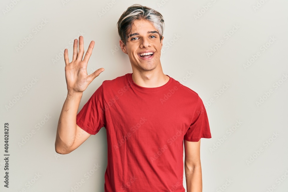 Young hispanic man wearing casual clothes showing and pointing up with fingers number five while smiling confident and happy. Young hispanic man wearing casual clothes showing and pointing up with fingers number five while smiling confident and happy.