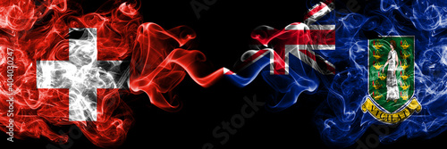 Switzerland, Swiss vs Britain, British Virgin Islands smoky mystic flags placed side by side. Thick colored silky abstract smoke flags.