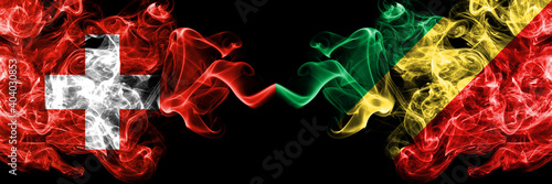 Switzerland, Swiss vs Congo, Congolese smoky mystic flags placed side by side. Thick colored silky abstract smoke flags.
