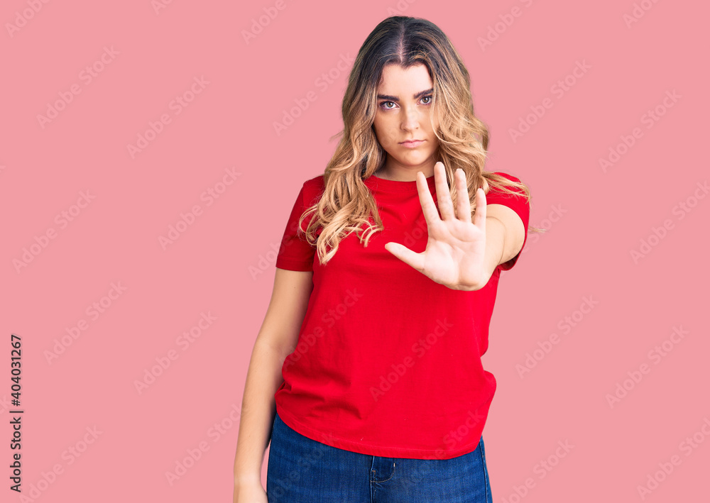 Young caucasian woman wearing casual clothes doing stop sing with palm of the hand. warning expression with negative and serious gesture on the face. Young caucasian woman wearing casual clothes doing stop sing with palm of the hand. warning expression with negative and serious gesture on the face.
